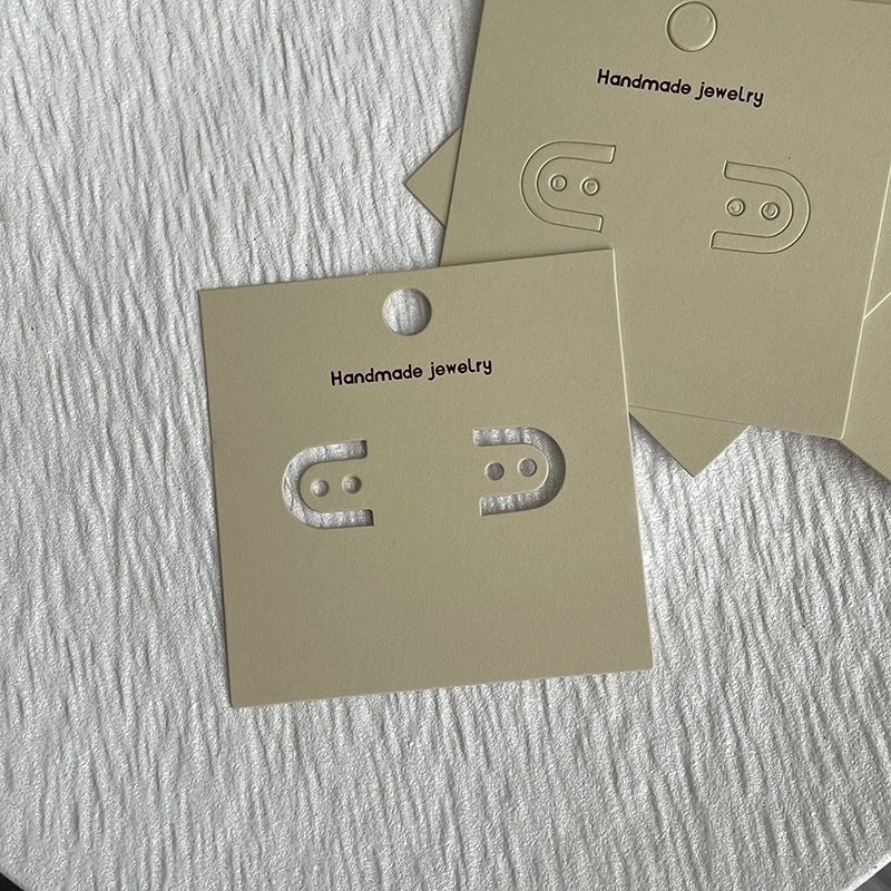 Black Logo Tag Earrings on Wrapping Card | Jewelry Accessories